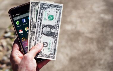 mobile-phone-money-banknotes-us-dollars-163069